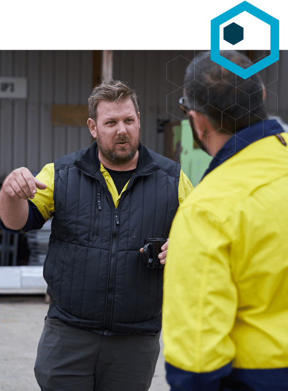 Two ReBuild workers having a conversation outside.