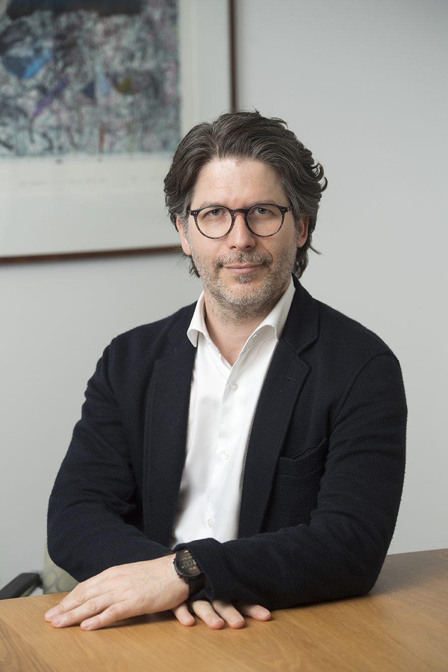Dr Alberto Furlan sitting at a desk