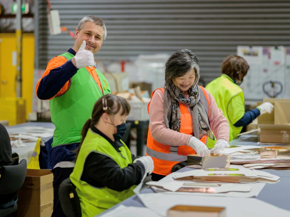 picture of Greg in a green vest, with thumbs up at Waverley Social Enterprises.