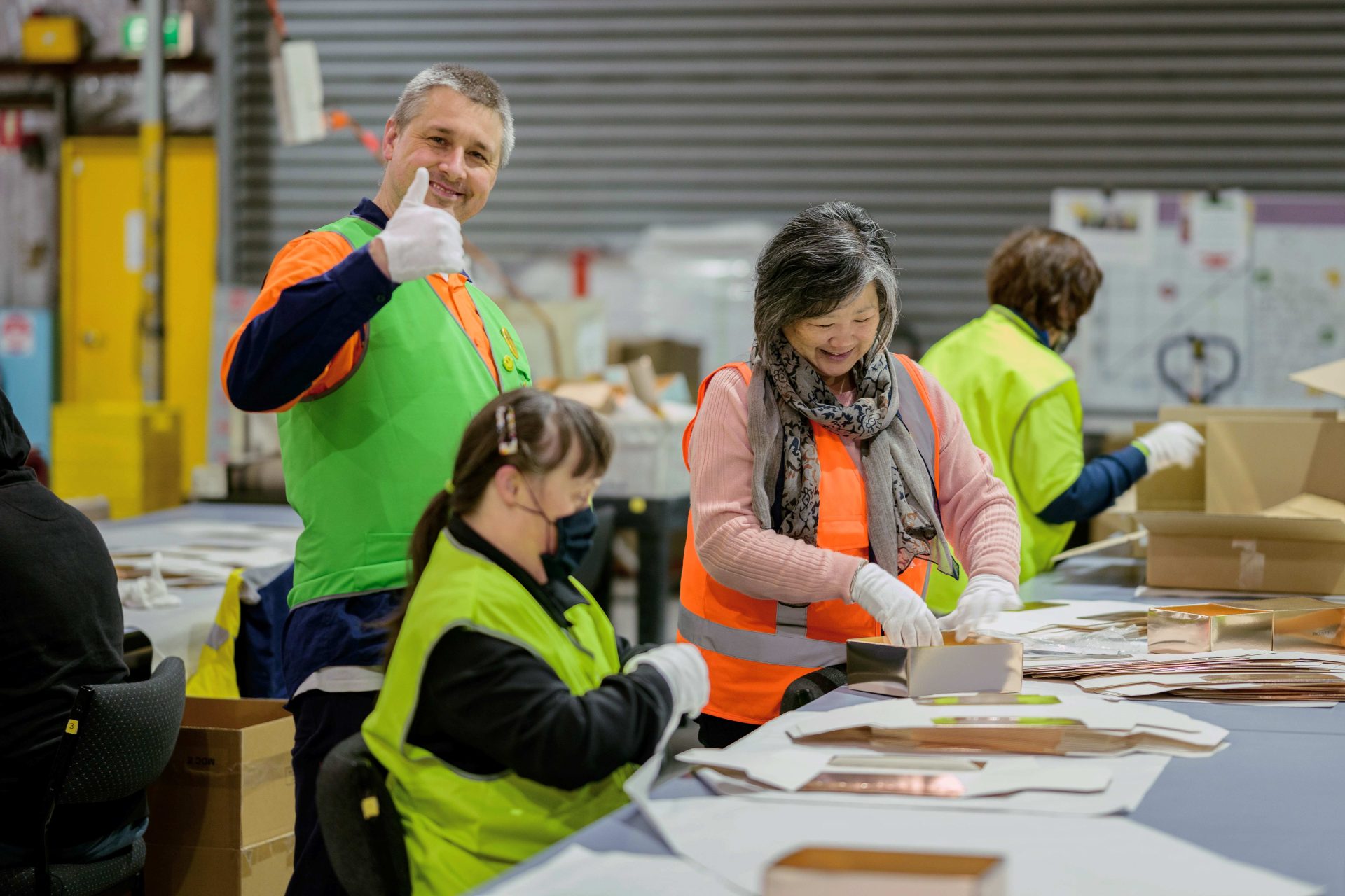 picture of Greg in a green vest, with thumbs up at Waverley Social Enterprises.