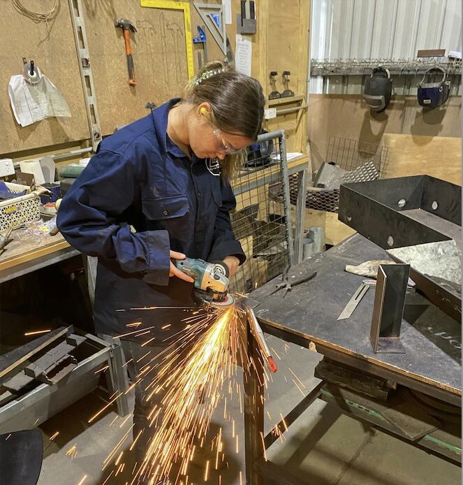 A young woman welding