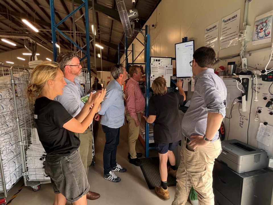 Beacon Laundry - people looking at equipment in the laundry