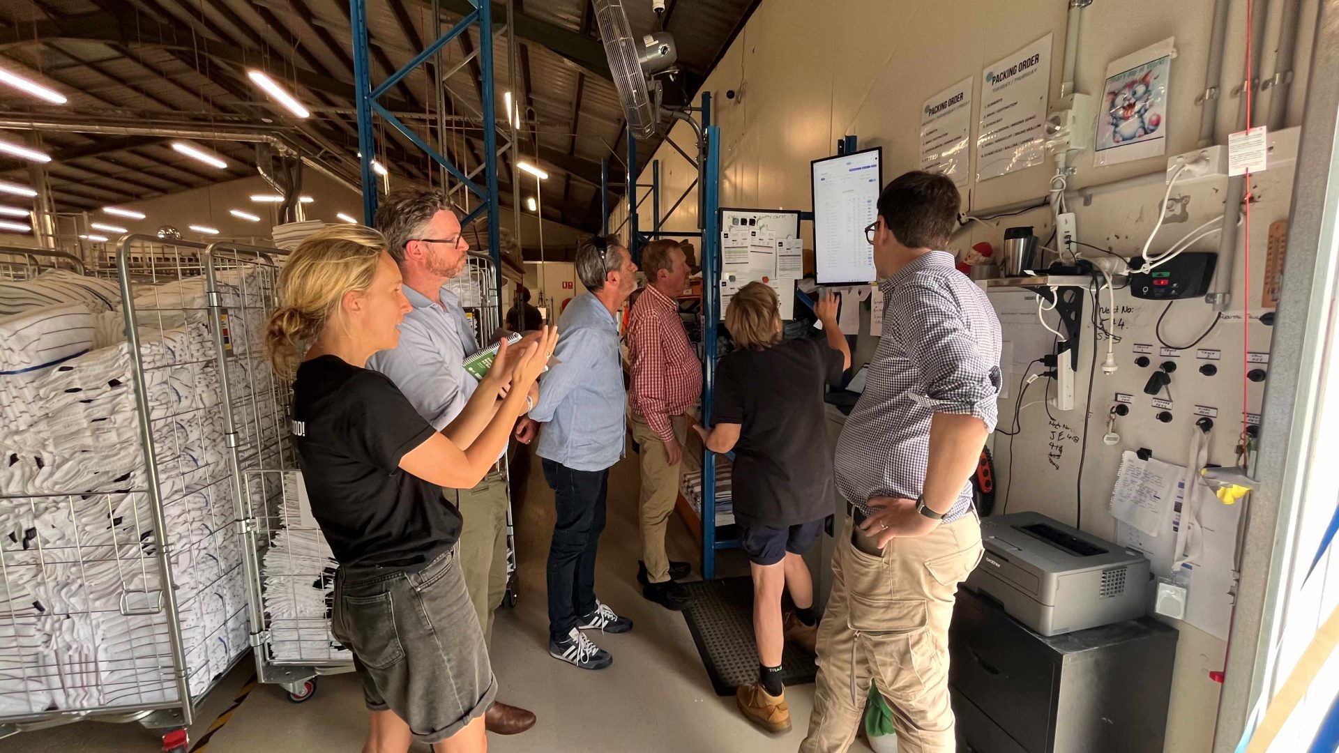 Beacon Laundry - people looking at equipment in the laundry