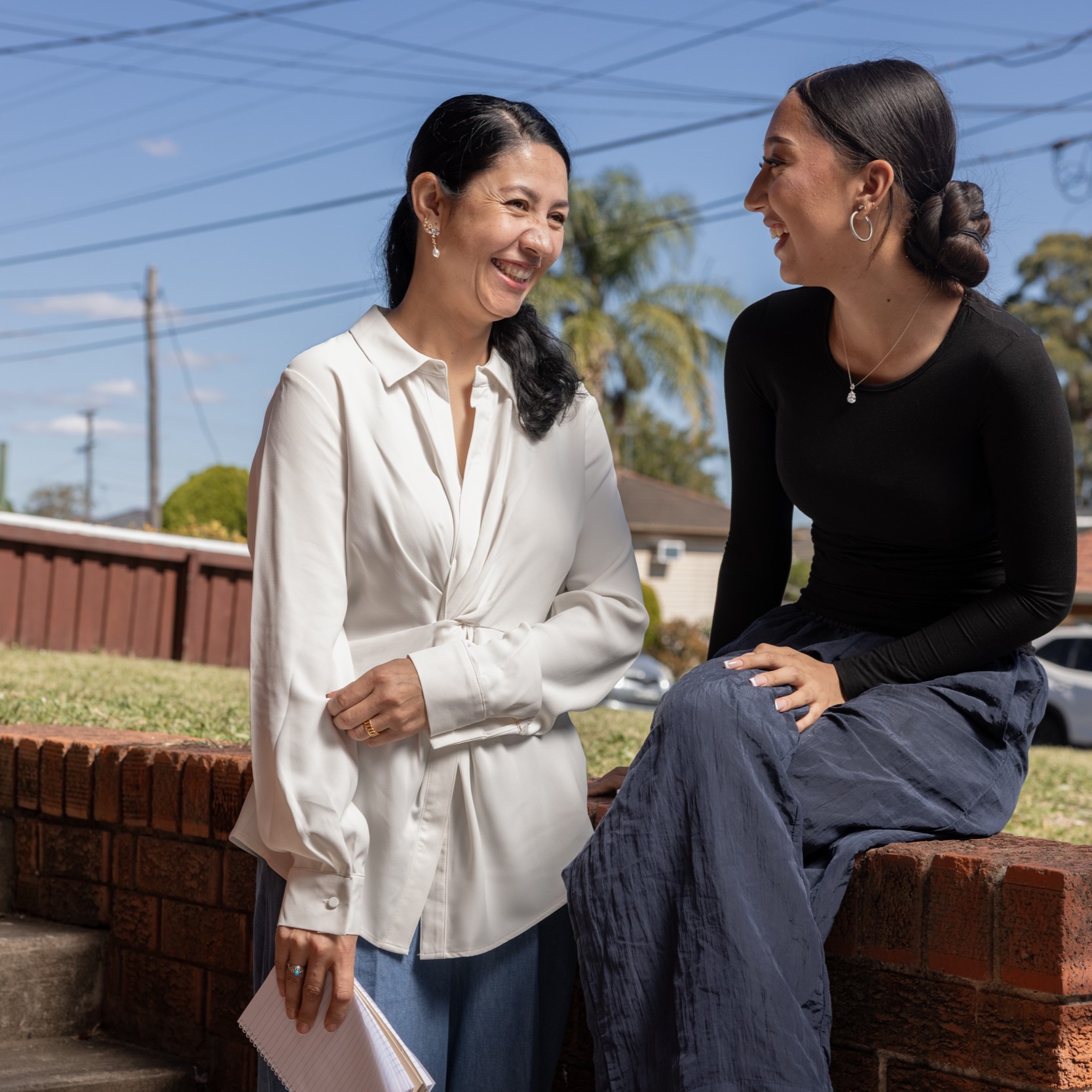A mother and daughter smiling at each other